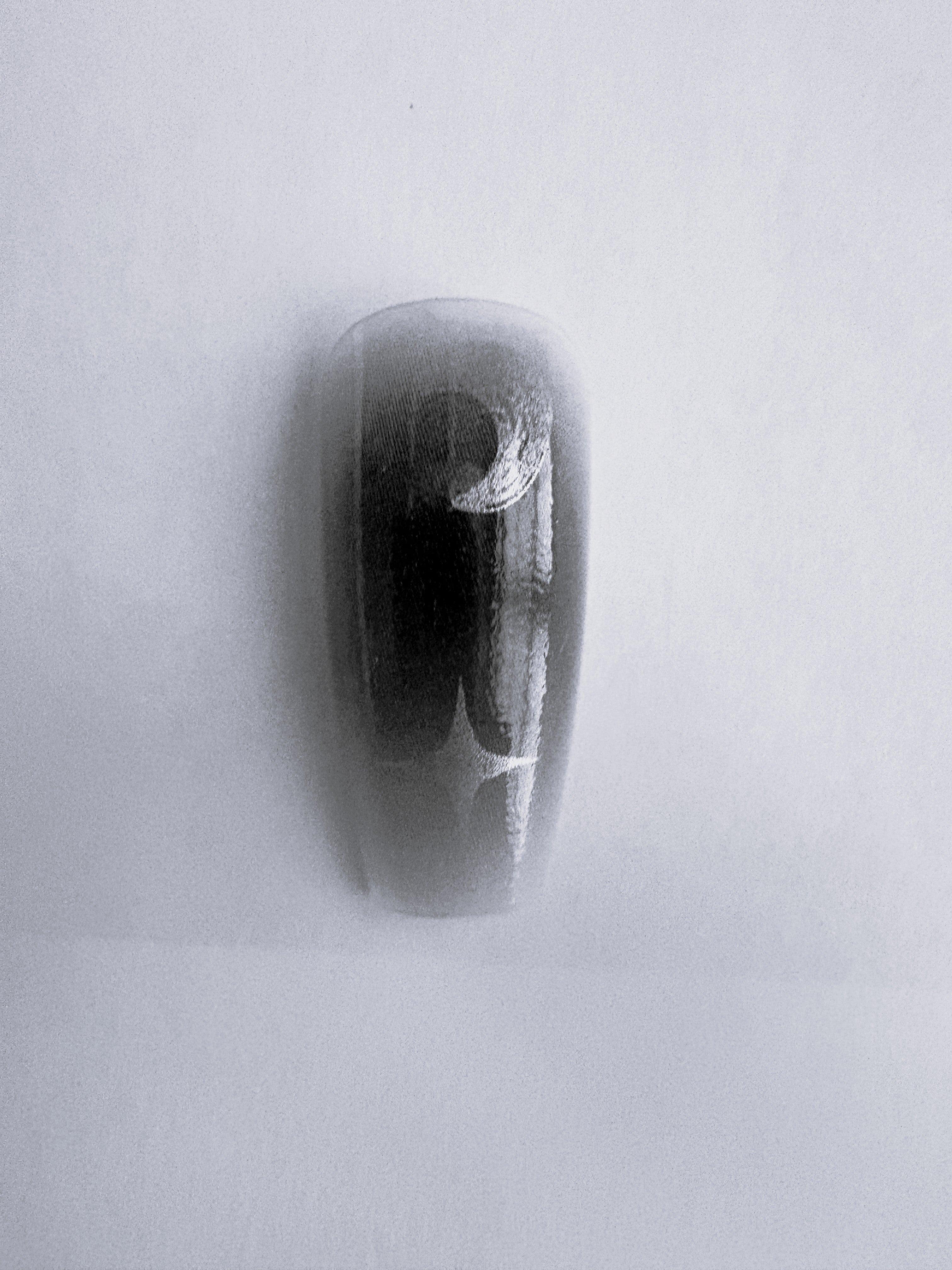 Press on long black decorative nails and eyelashes set on a light gray background