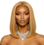 Woman with styled honey blonde hair and jewelry on a white background